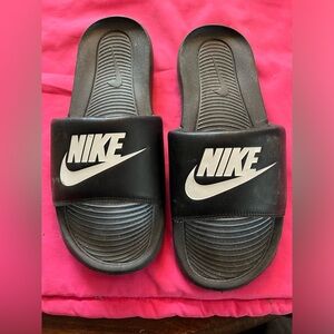 Black with white cutouts women’s Nike slide